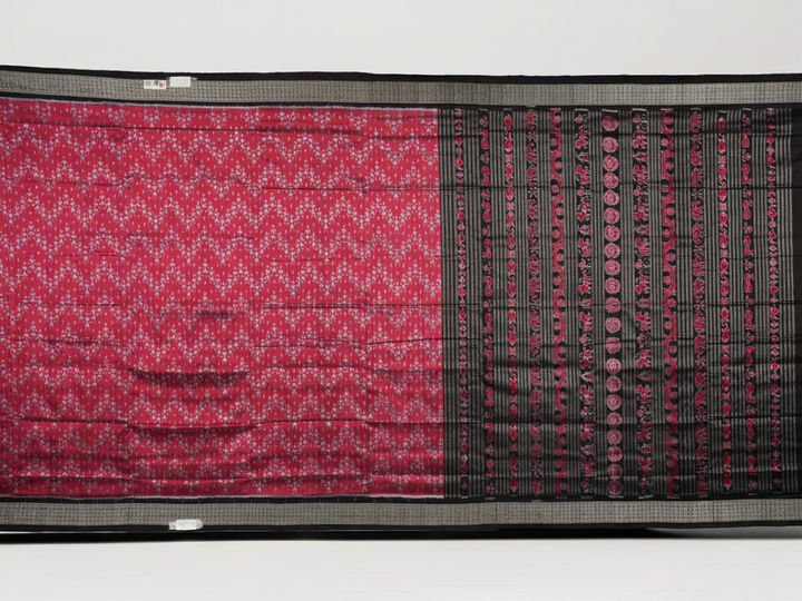 Detailed close-up of the maroon and black Sambalpuri silk saree's luxurious fabric texture and weave.