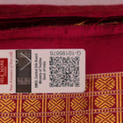 Close-up of luxurious green silk tissue saree fabric, showcasing intricate butta weaving details.