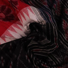 Saree styling: A red and black Sambalpuri cotton handloom saree with motifs is beautifully draped.