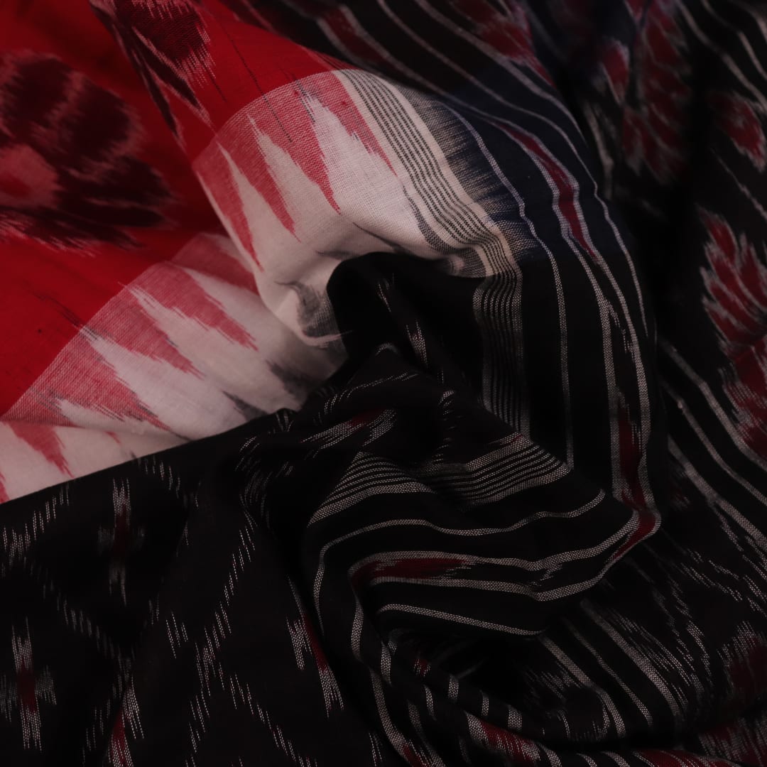 Saree styling: A red and black Sambalpuri cotton handloom saree with motifs is beautifully draped.