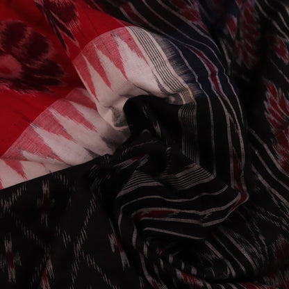 Saree styling: A red and black Sambalpuri cotton handloom saree with motifs is beautifully draped.