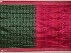 Close-up of textured green Sambalpuri silk saree fabric with magenta motifs.