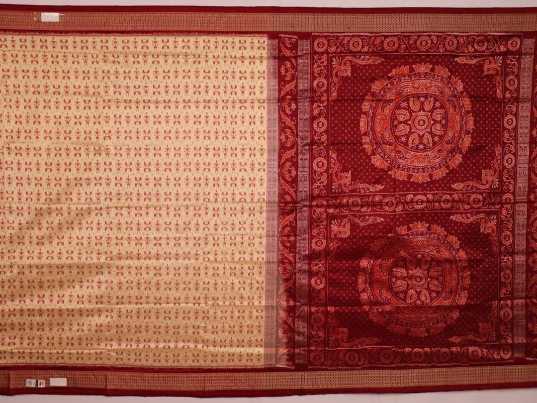 Close-up showcasing the intricate cream and maroon silk fabric texture with Sambalpuri motifs