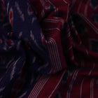 Gracefully draped blue Sambalpuri cotton saree with red motifs, highlighting its design and flow.
