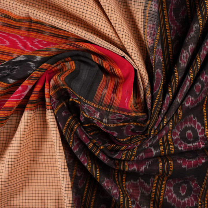 Model elegantly draped in a cream and black Sambalpuri cotton handloom saree with traditional ikat motifs.