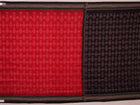 Red and black Sambalpuri cotton saree with motifs, elegantly draped to showcase its style and design.