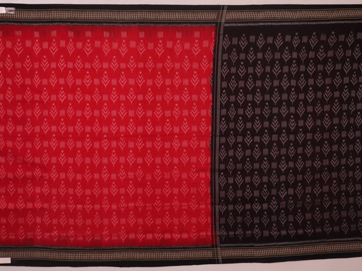 Red and black Sambalpuri cotton saree with motifs, elegantly draped to showcase its style and design.