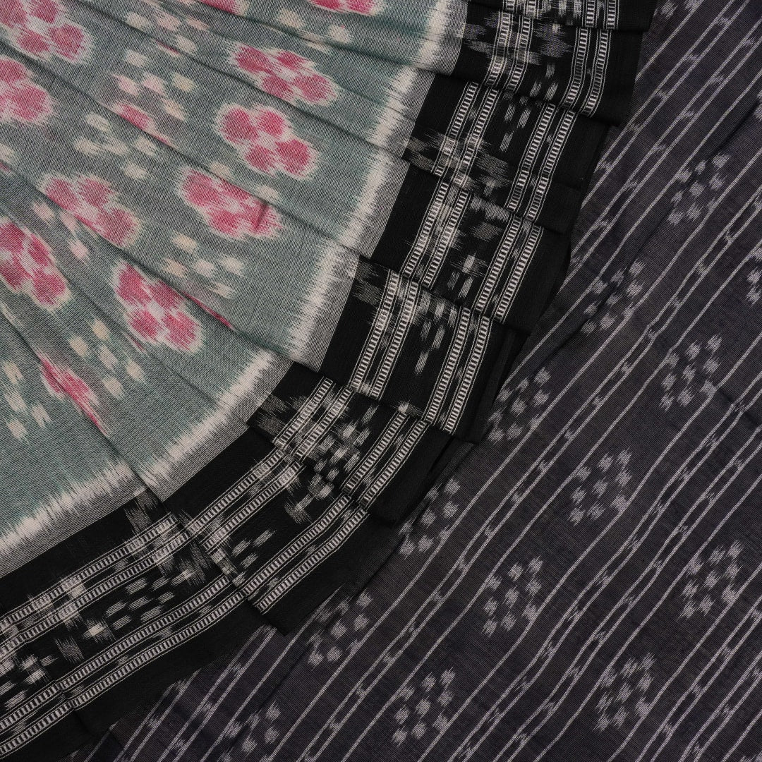 Model wearing a green and black Sambalpuri cotton saree showcasing traditional handloom drape and motifs.