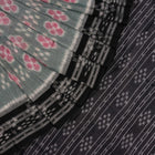 Model wearing a green and black Sambalpuri cotton saree showcasing traditional handloom drape and motifs.