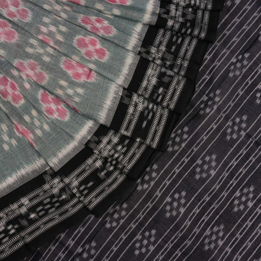 Model wearing a green and black Sambalpuri cotton saree showcasing traditional handloom drape and motifs.