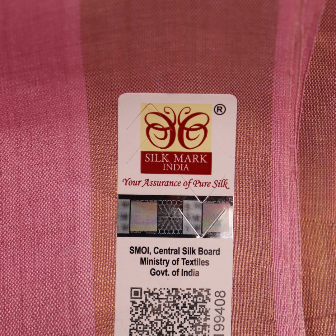 Close-up view of the smooth, textured tussar silk fabric in a delicate pink hue, showcasing the intricate butta pattern.