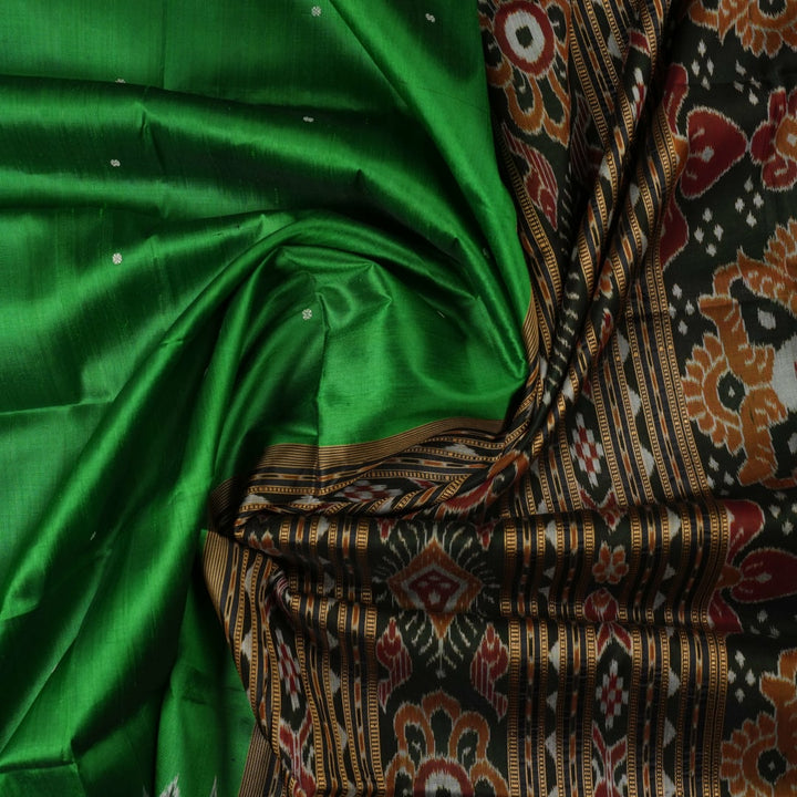 Model draped in a green and black Khandua silk saree with butta work, showcasing elegant ethnic styling.