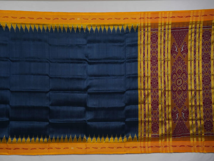 Model styling a blue and yellow Khandua silk saree with traditional butta work and border.