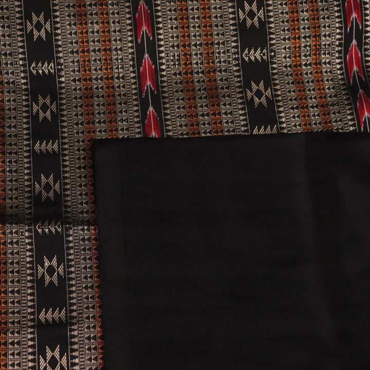 Close-up texture of handwoven Bomkai silk saree fabric: maroon and black threads forming butta pattern.