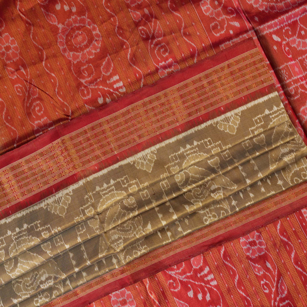 Ultra close-up of Sambalpuri silk saree fabric, showing luxurious texture and tissue motif weave.