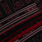 Red and black Sambalpuri cotton saree draped, showcasing overall styling and motifs.