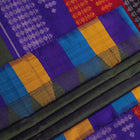 Close-up of the green silk fabric with a butta pattern in the Berhampuri saree