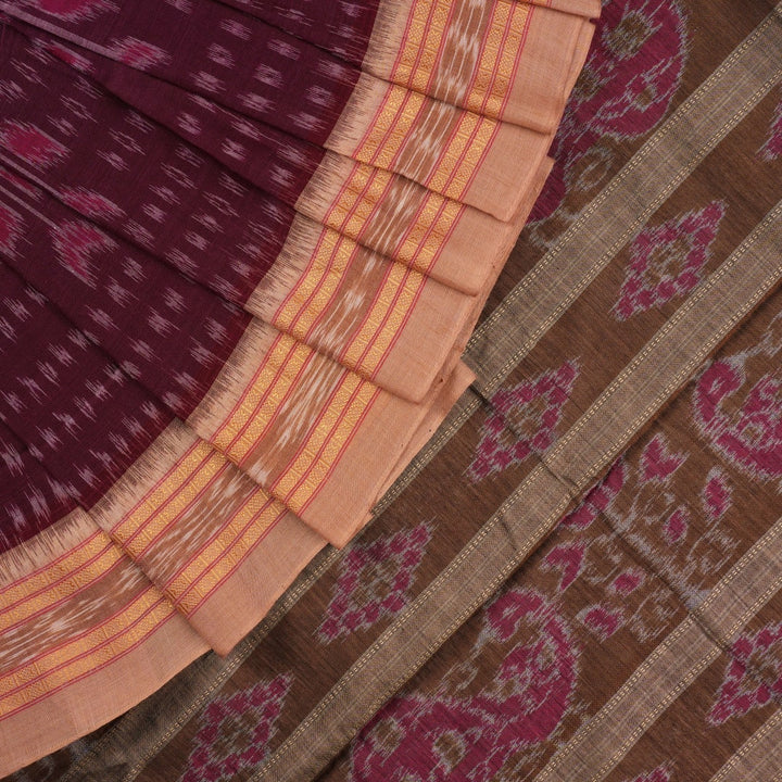 Model wearing an elegantly draped maroon and brown Sambalpuri cotton saree with traditional ikat motifs.