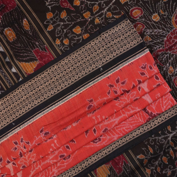 Full layout view of a rust and black Sambalpuri cotton saree displaying the complete body pattern and motifs.
