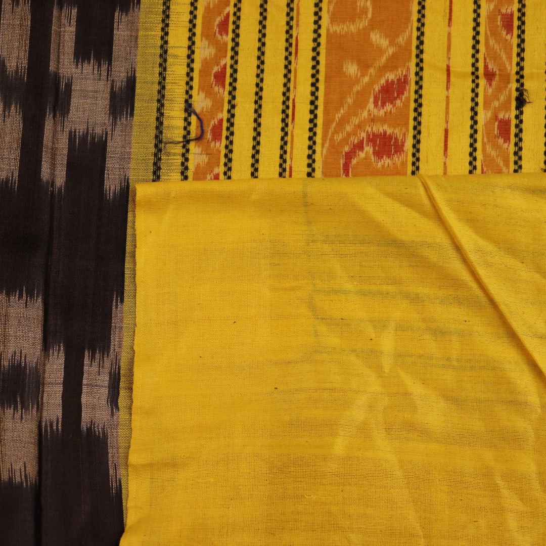 Close-up of black and gold Tussar silk saree fabric with intricate motif patterns