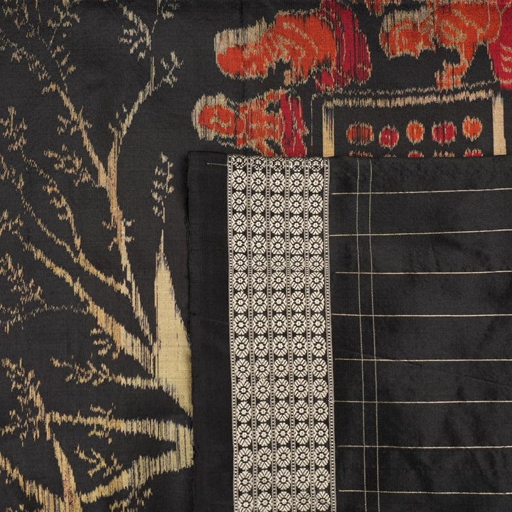 Close-up of the luxurious black Sambalpuri silk fabric, highlighting its rich texture and weave.
