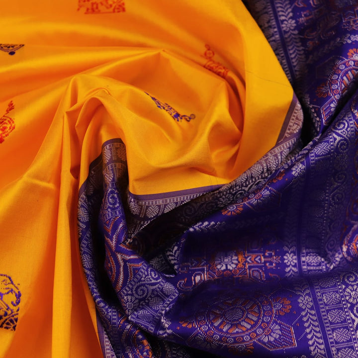 Close-up showcasing the yellow and blue butta pattern on the silk Bomkai saree fabric.