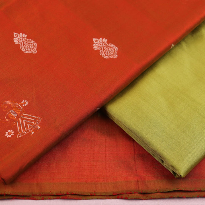 Detail of rust and green Bomkai silk blouse piece with butta pattern.