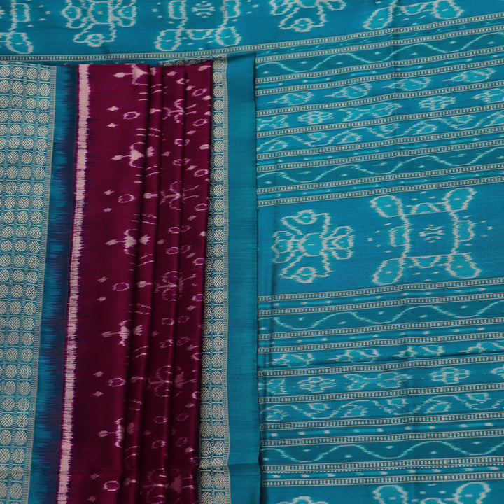 Close-up showcasing the purple and blue silk fabric texture of the Sambalpuri saree with intricate motifs.