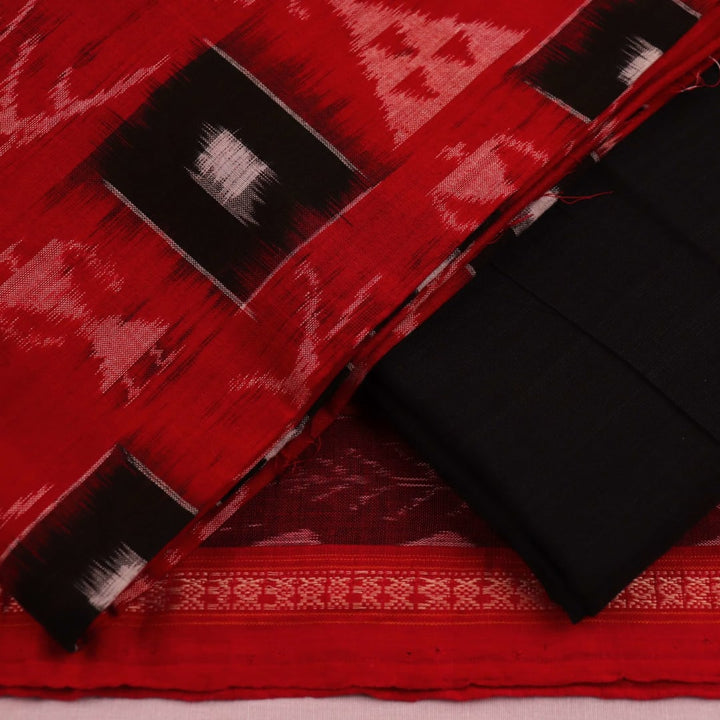 Close-up detail of motifs on a red and black cotton Sambalpuri dress material