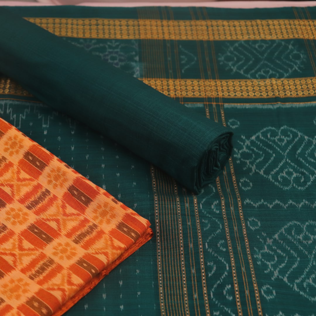 Blouse piece detail of the rust and green Sambalpuri cotton dress material with motifs.