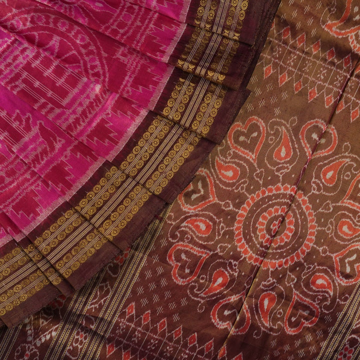 Close-up of Sambalpuri silk fabric texture, highlighting the fine weave in pink and maroon with delicate tissue motifs.