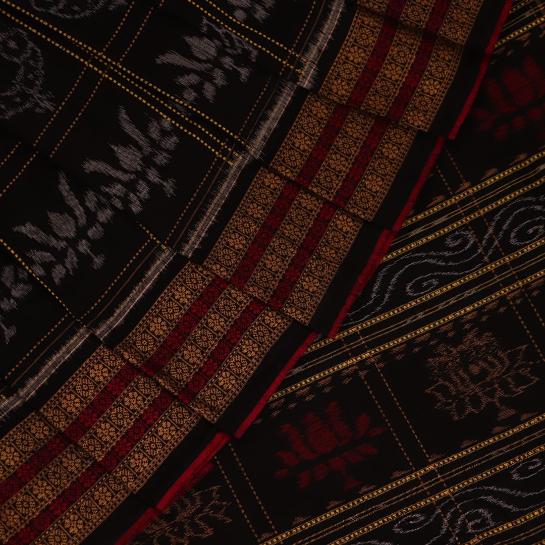 Full view of a black and black cotton Sambalpuri saree with intricate motif patterns.