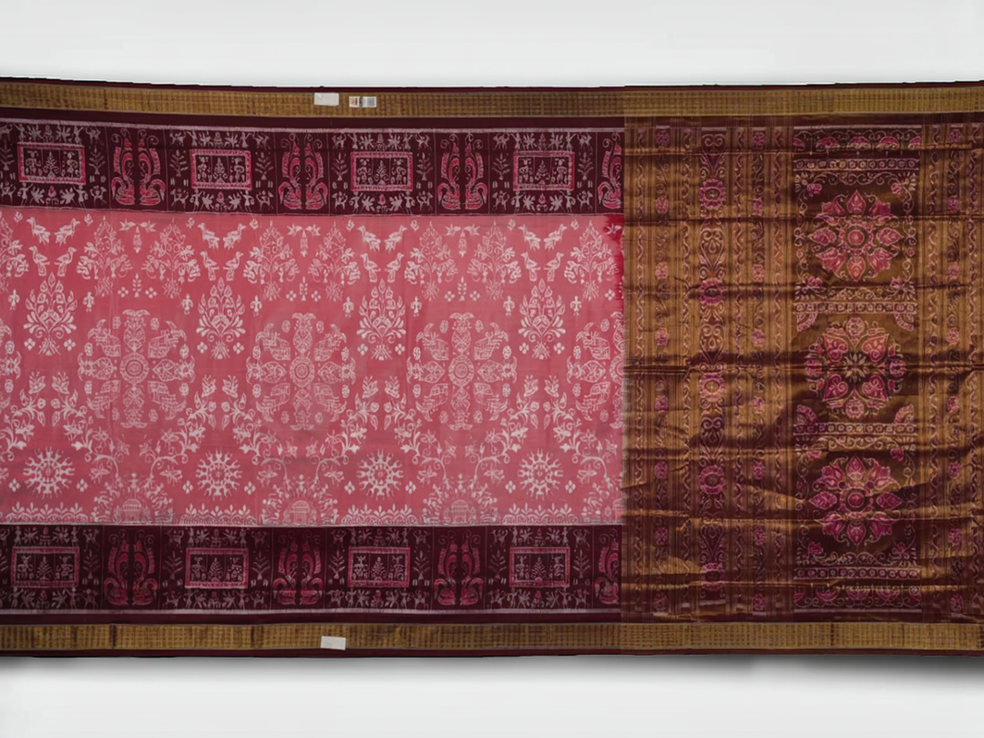 Close-up of luxurious silk fabric texture and intricate weave details of the multi-color Sambalpuri saree.