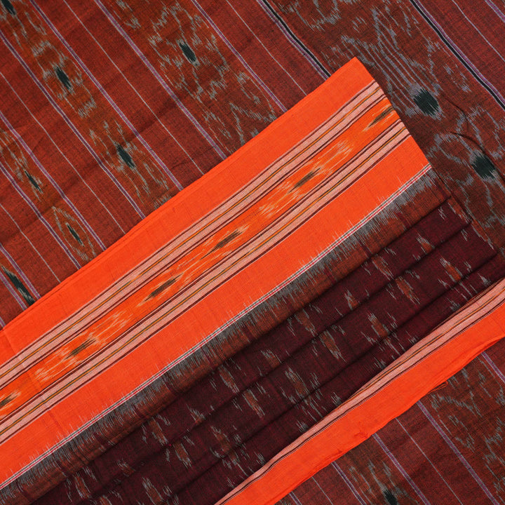 Model draped in a maroon and orange Sambalpuri cotton saree showcasing traditional handloom motifs.