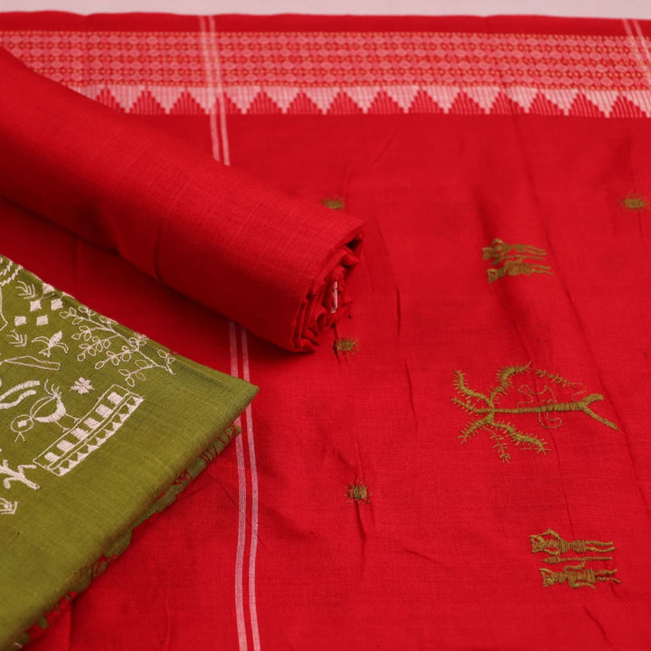 Close-up of a green cotton Sambalpuri dress material with a red doll pattern blouse piece.