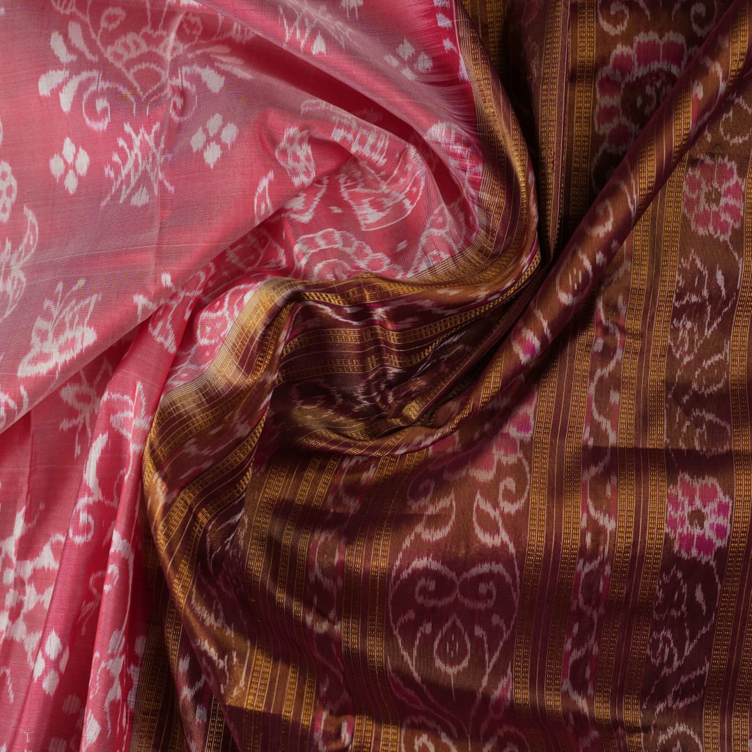 Close-up of luxurious silk fabric texture and intricate weave details of the multi-color Sambalpuri saree.