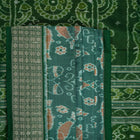 Ultra close-up of green Sambalpuri silk saree fabric, highlighting its luxurious texture and weave.