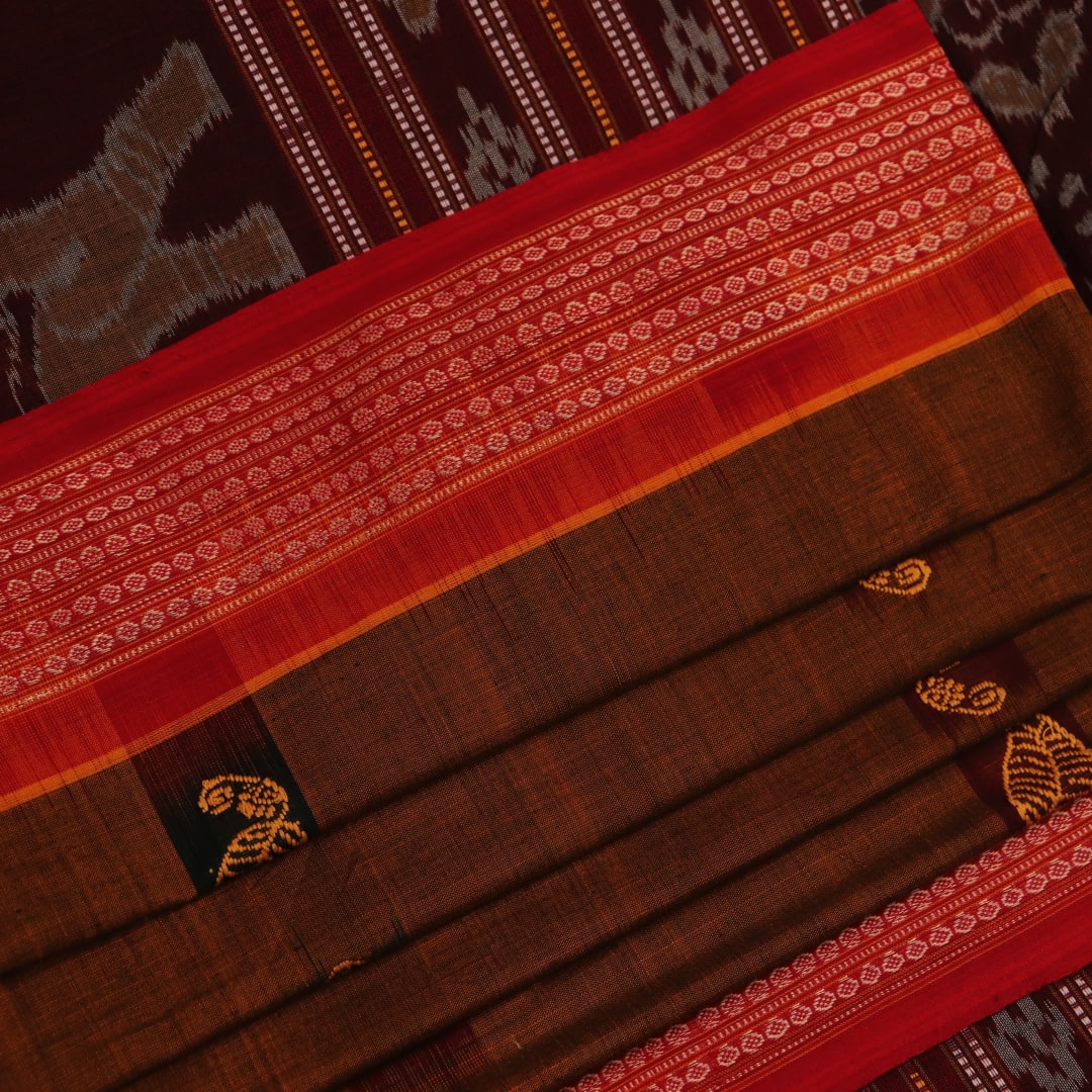 A brown and red Bomkai cotton saree with butta pattern on display