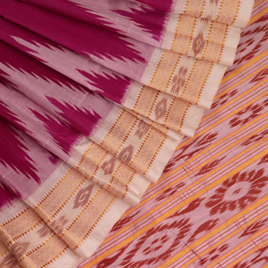 Pink and off white silk Khandua saree draped in a stylish manner, showcasing the intricate butta pattern and border details.