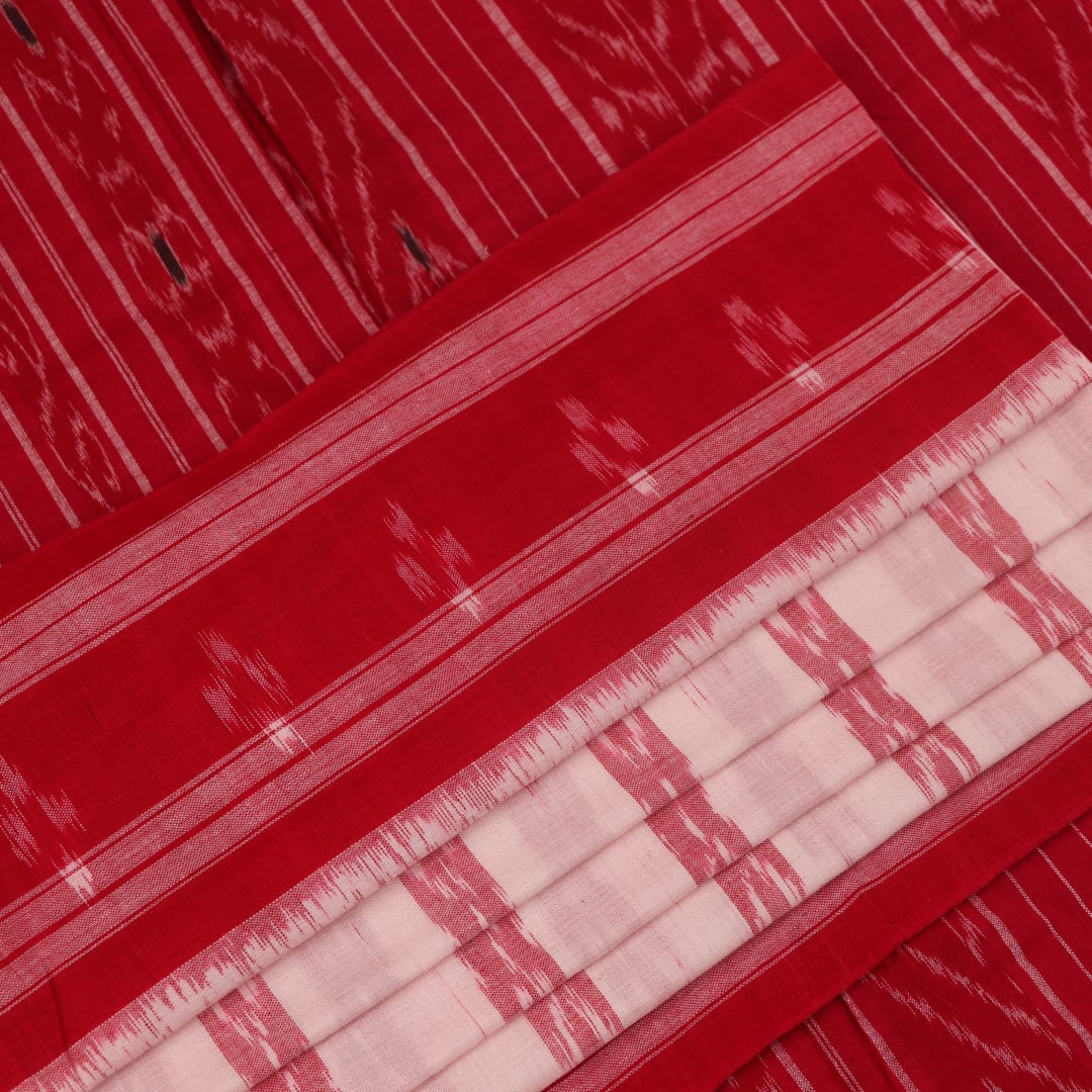 White and red cotton Sambalpuri Saree with motifs, elegantly draped.