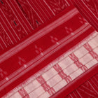 White and red cotton Sambalpuri Saree with motifs, elegantly draped.
