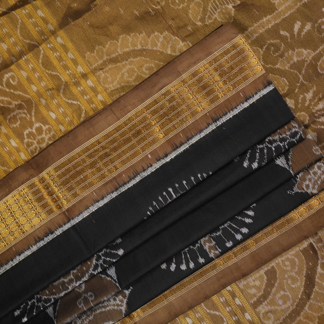 Close-up revealing the delicate, lustrous texture of the black silk tissue saree fabric with subtle sheen.