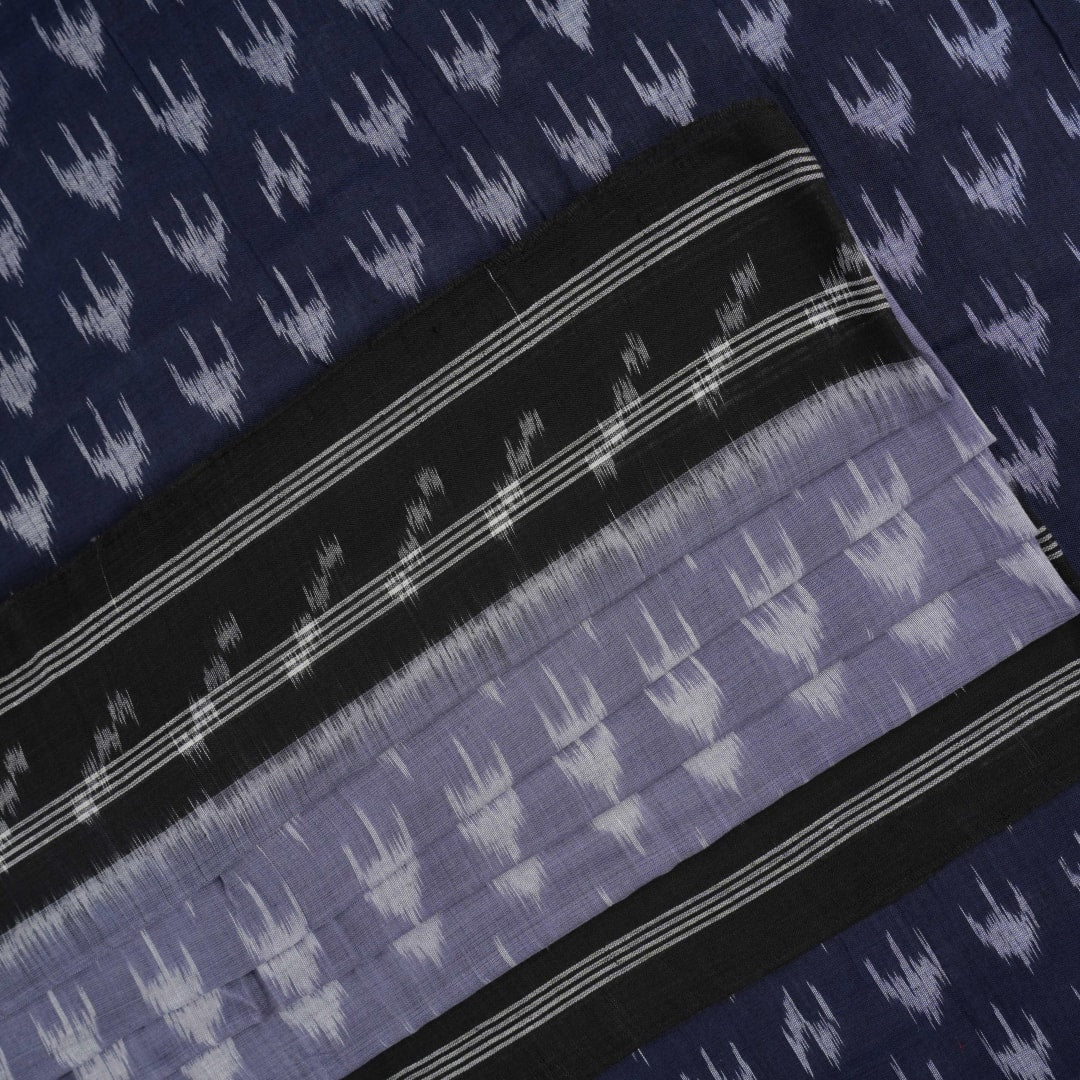 Model wearing a grey and black Sambalpuri cotton saree with traditional ikat motifs in a classic ethnic drape.