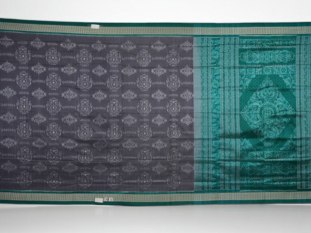 Extreme close-up of grey Sambalpuri silk fabric, revealing its fine handloom texture and weave quality.