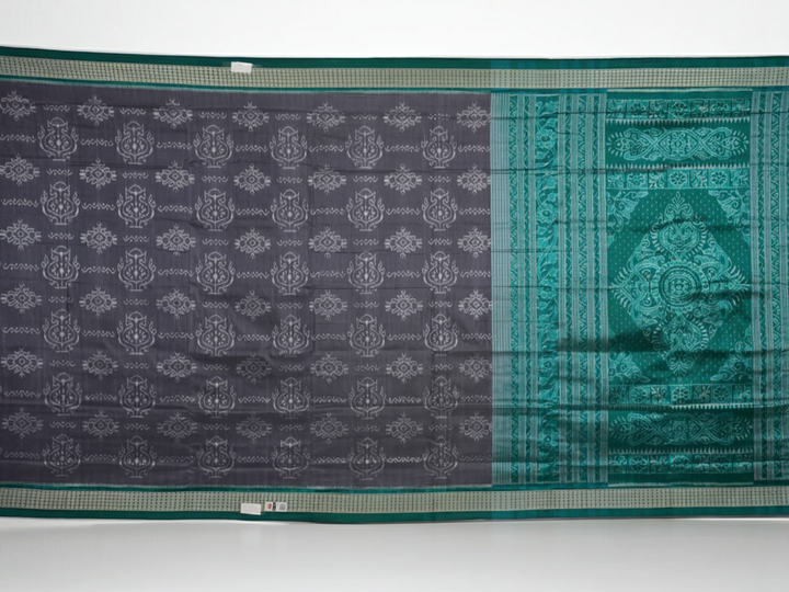 Extreme close-up of grey Sambalpuri silk fabric, revealing its fine handloom texture and weave quality.