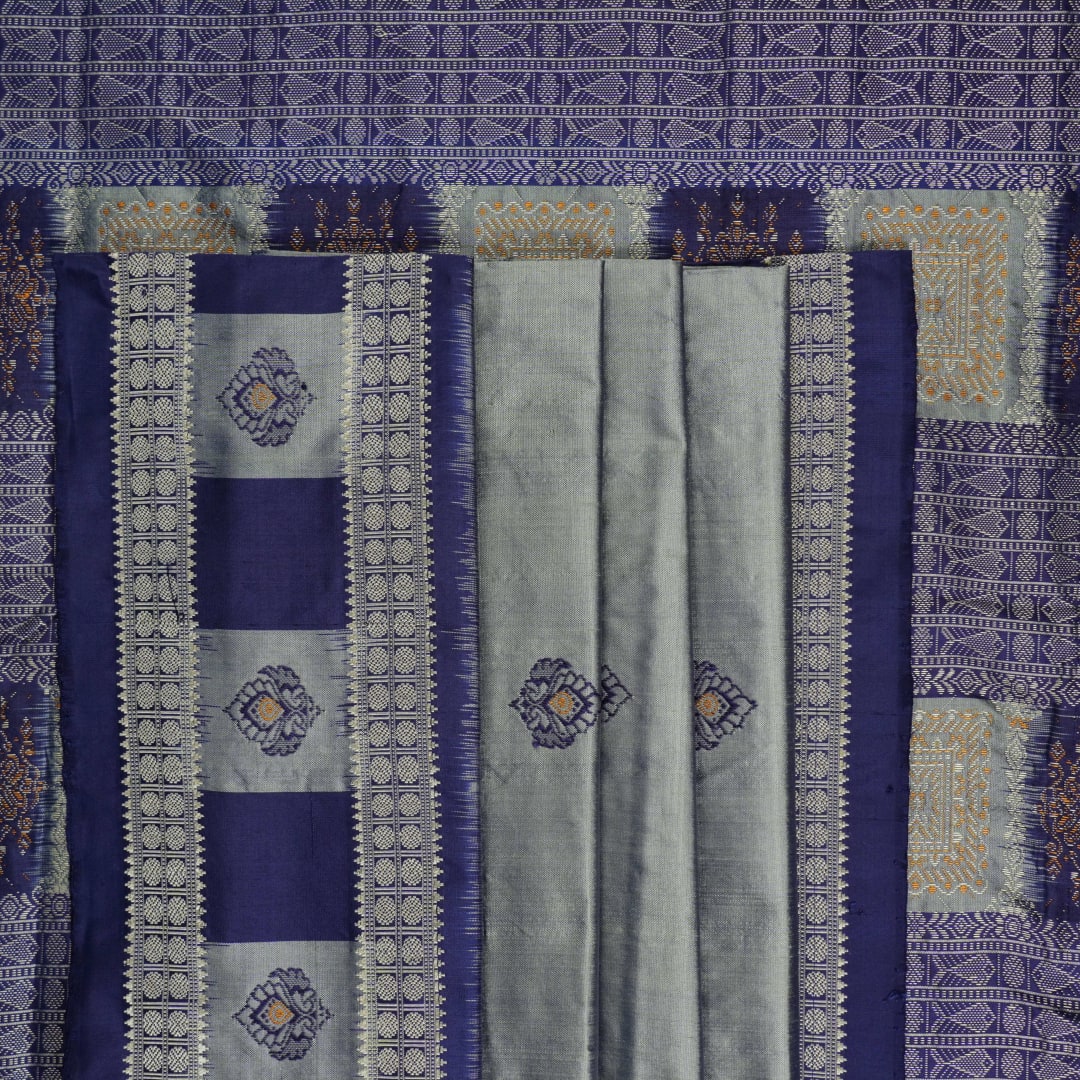 Close-up of luxurious Bomkai Silk Saree fabric texture, highlighting grey and blue handloom weave.
