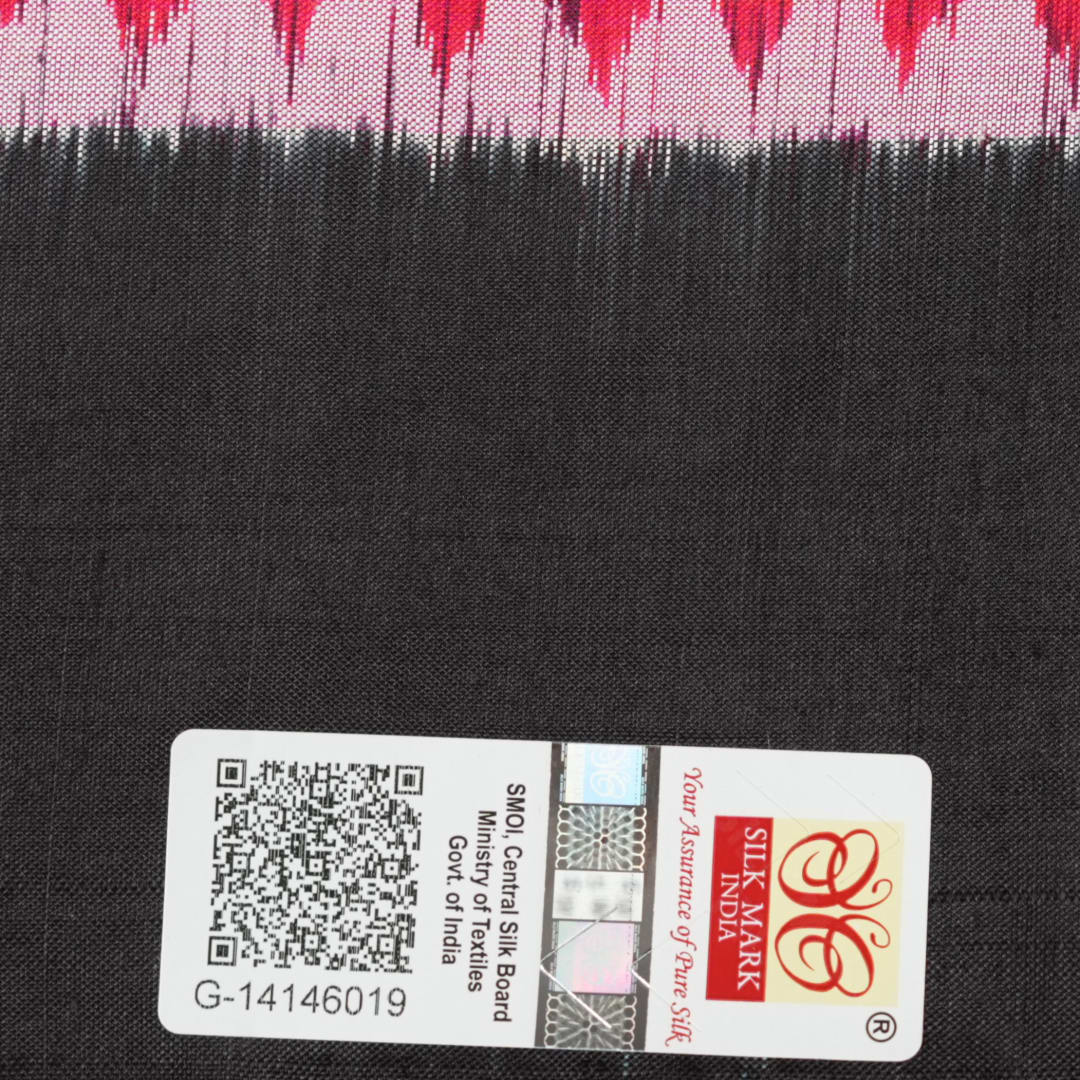 Close-up of the luxurious, handloom silk texture of the red Sambalpuri saree, showing the weave.