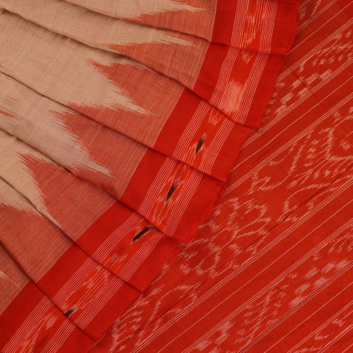 Cream and orange Sambalpuri cotton saree draped, showcasing traditional motifs and handloom texture.