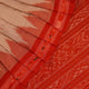 Cream and orange Sambalpuri cotton saree draped, showcasing traditional motifs and handloom texture.