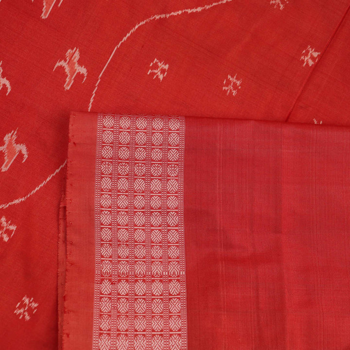 Close-up showcasing the intricately woven silk fabric texture of a multi-colored Sambalpuri saree with traditional motifs.